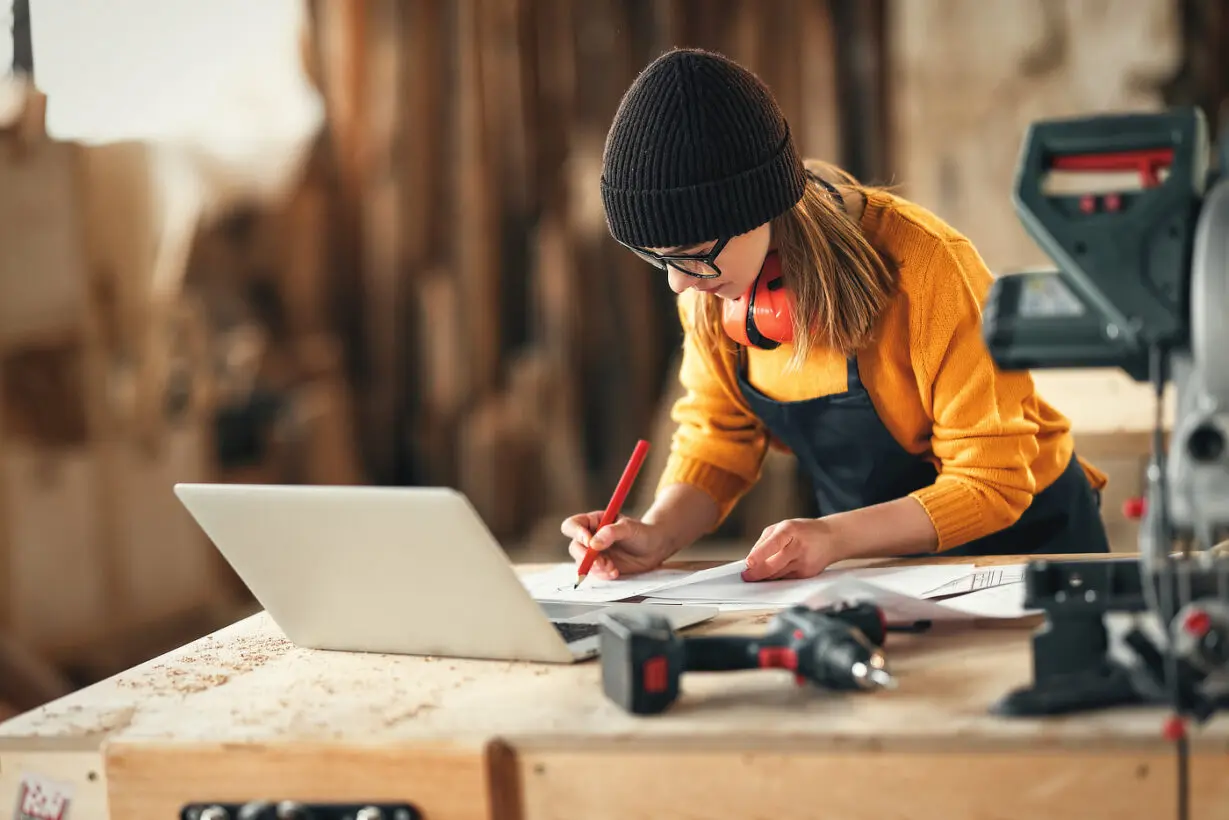 Artisan woman working in carpentry workshop